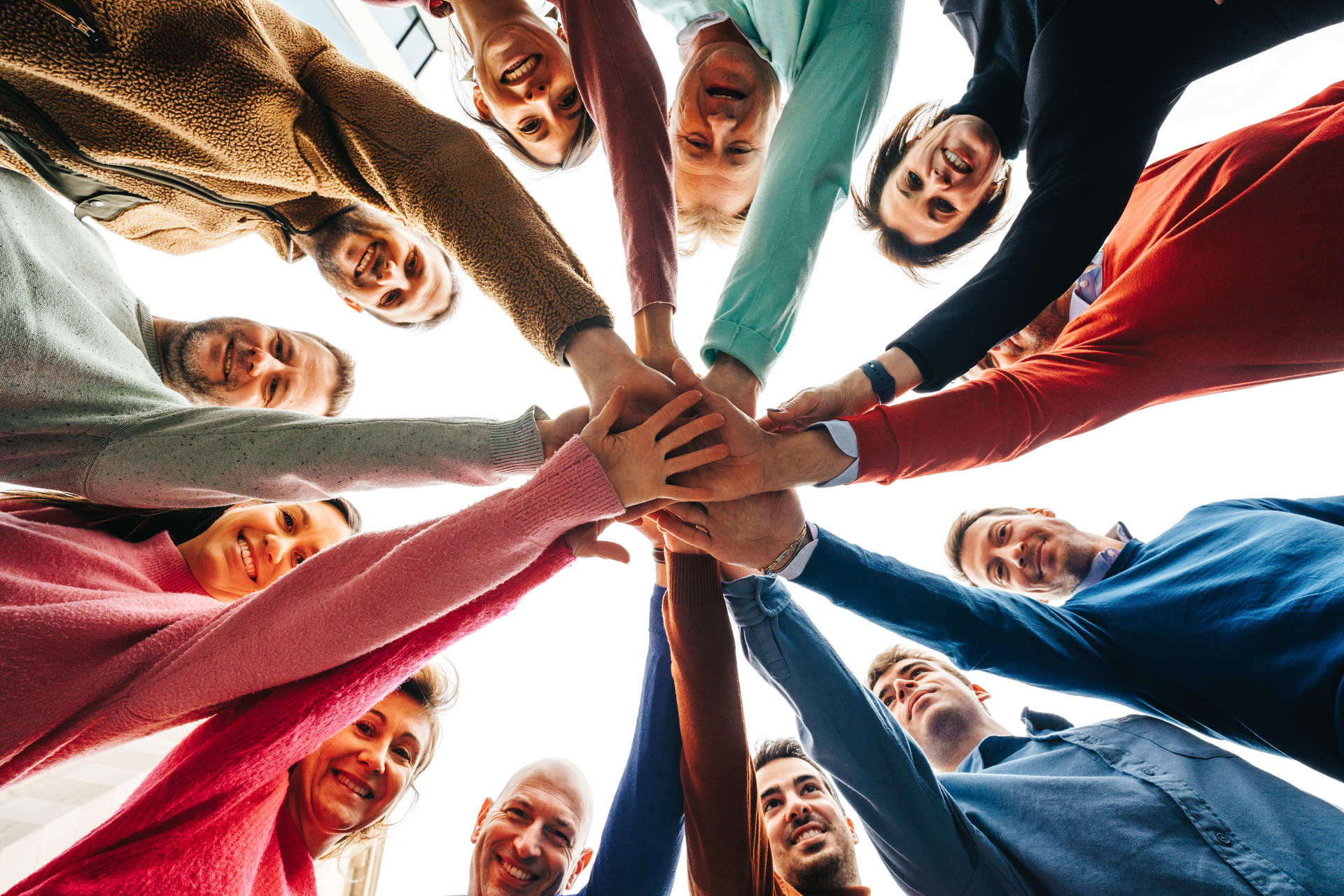 Fluxys team Support Services grouping hands.